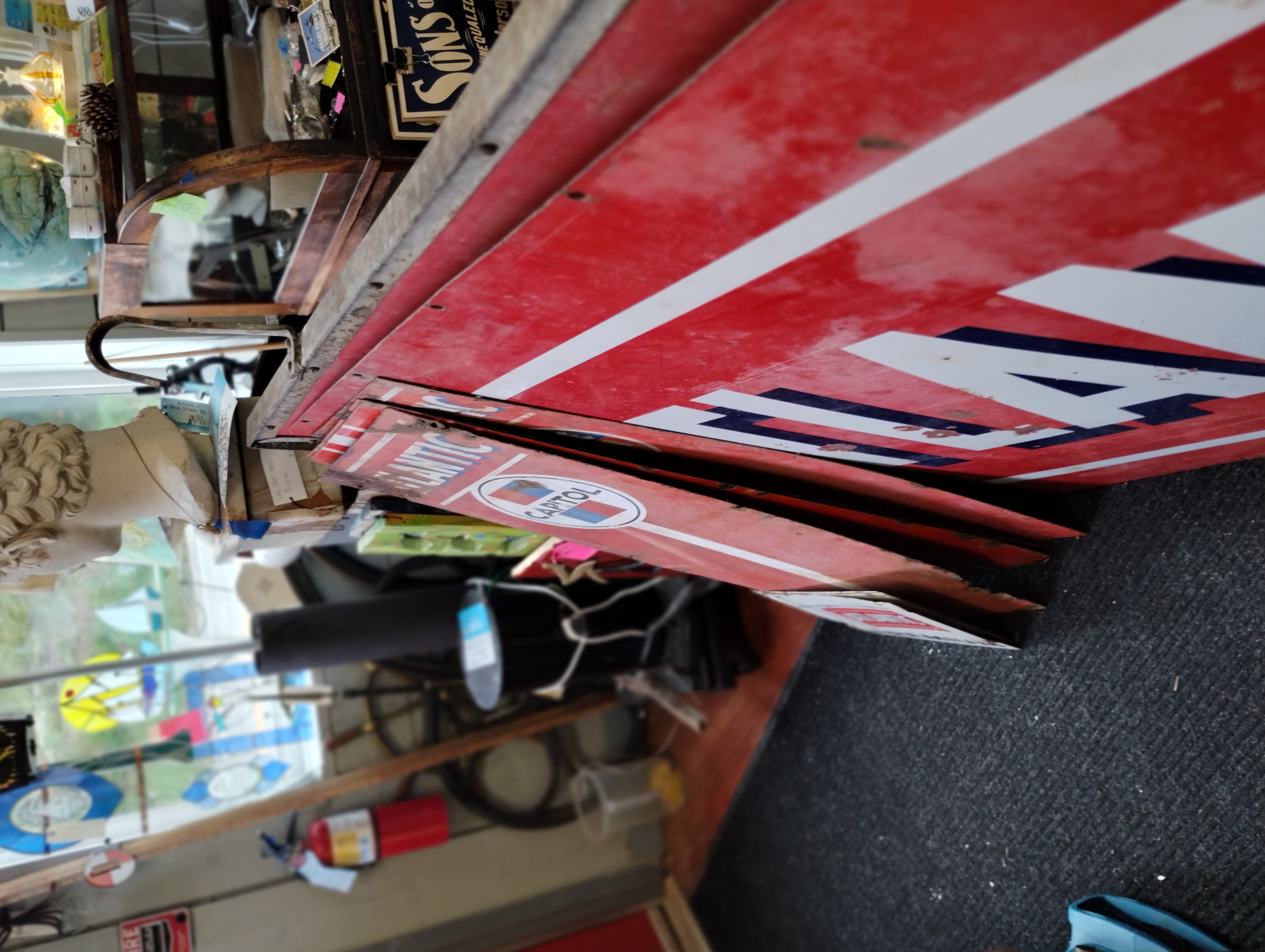 Vintage advertising signs including Amoco and Sunoco